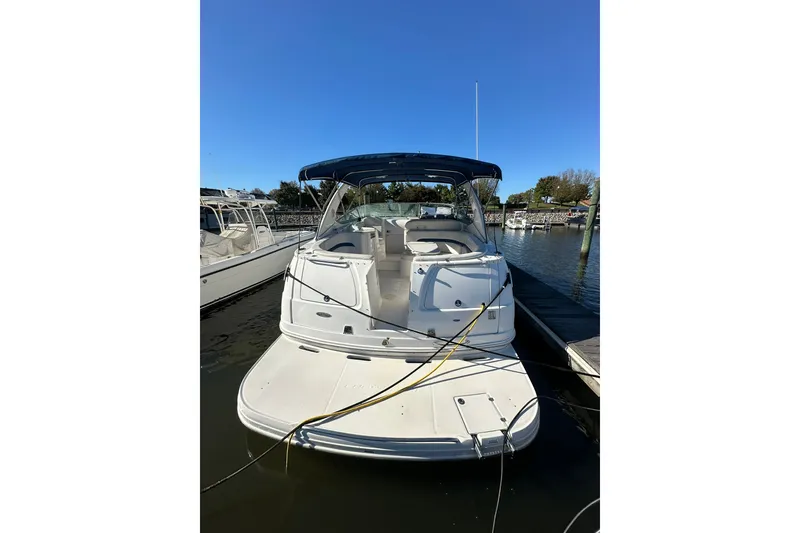 Slide: The Image of Chaparral Signature 320 boat, 2002 model, docked at a marina under clear blue sky. - 8