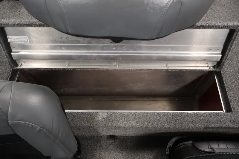 Slide: The Image of 2019 Tracker Pro 170 boat storage compartment with gray seating and carpeted interior. - 28