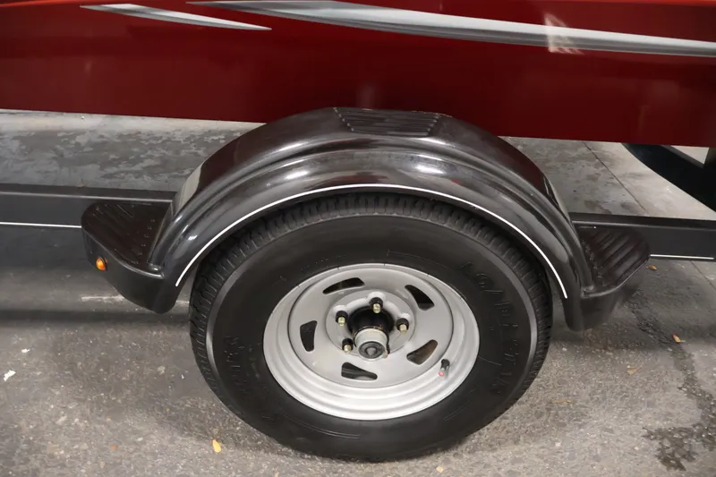 Slide: The Image of Trailer wheel of 2019 Tracker Pro 170 boat, featuring black fender and silver rim. - 35