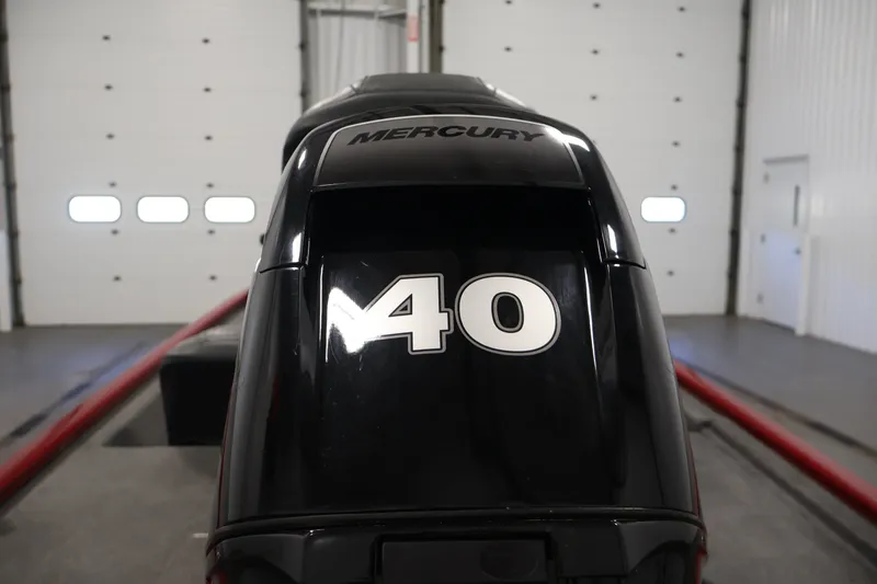 Slide: The Image of 2019 Tracker Pro 170 with Mercury 40 outboard motor in a garage setting. - 31