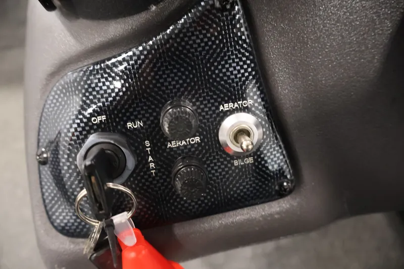 Slide: The Image of Control panel of a 2019 Tracker Pro 170 boat with ignition and aerator switches. - 24