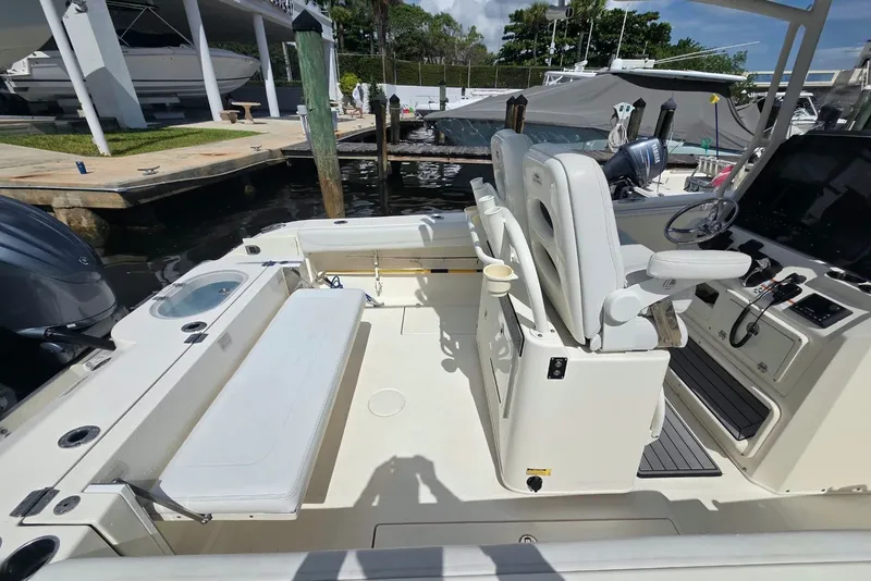 Slide: The Image of 2022 Cobia 280 Center Console boat interior with seating and control panel. - 15