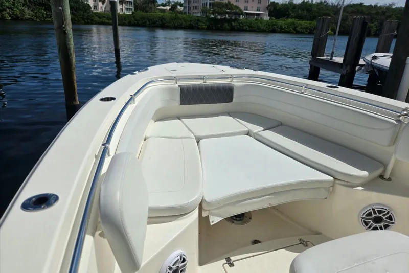 Slide: The Image of 2022 Cobia 280 Center Console boat with spacious seating area by the water. - 18