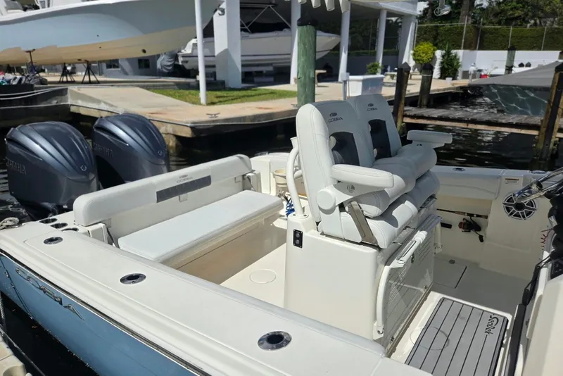 Slide: The Image of 2022 Cobia 280 Center Console boat with dual engines docked at marina. - 19