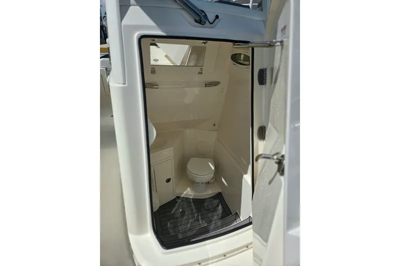 Slide: The Image of Interior view of 2022 Cobia 280 Center Console boat's compact bathroom. - 22