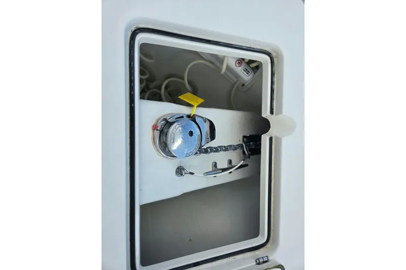 Slide: The Image of 2022 Cobia 280 Center Console anchor locker with chain and winch. - 24