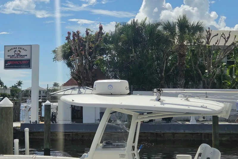 Slide: The Image of 2022 Cobia 280 Center Console boat docked at Marina Delray under a sunny sky. - 6
