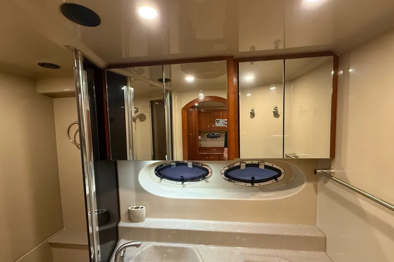 Slide: The Image of Luxurious bathroom interior of 2004 Cruisers Yachts 405 Express Motoryacht with mirrors and portholes. - 84