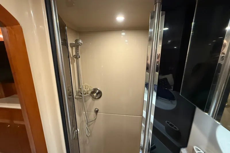 Slide: The Image of Shower area in 2004 Cruisers Yachts 405 Express Motoryacht, featuring modern fixtures and lighting. - 86