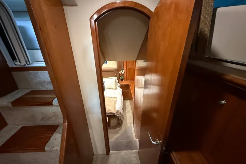 Slide: The Image of Interior view of 2004 Cruisers Yachts 405 Express Motoryacht cabin with wooden door and cozy bed. - 71