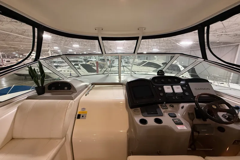 Slide: The Image of 2004 Cruisers Yachts 405 Express Motoryacht helm with Garmin navigation in a showroom. - 24