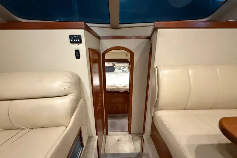 Slide: The Image of Interior of 2004 Cruisers Yachts 405 Express Motoryacht with beige seating and wood accents. - 52