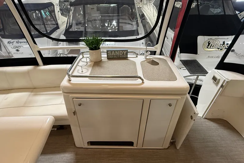Slide: The Image of 2004 Cruisers Yachts 405 Express Motoryacht interior with kitchenette and seating area. - 11