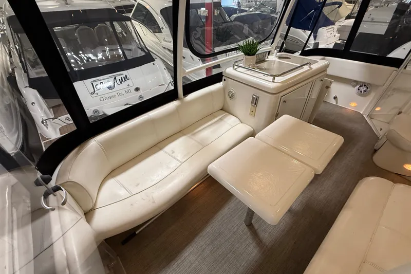 Slide: The Image of Luxurious interior of 2004 Cruisers Yachts 405 Express Motoryacht with white seating and table. - 16