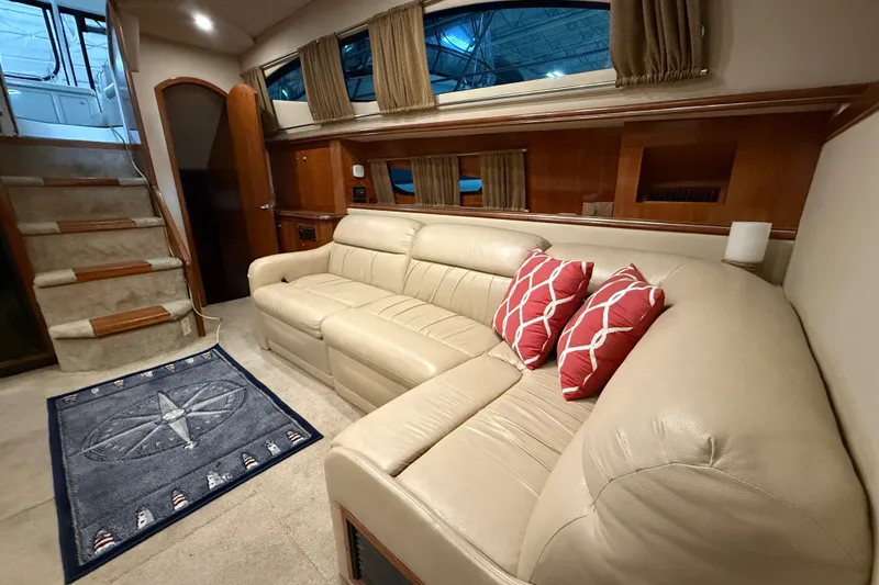 Slide: The Image of Luxurious 2004 Cruisers Yachts 405 Express Motoryacht interior with beige leather sofa and nautical decor. - 70