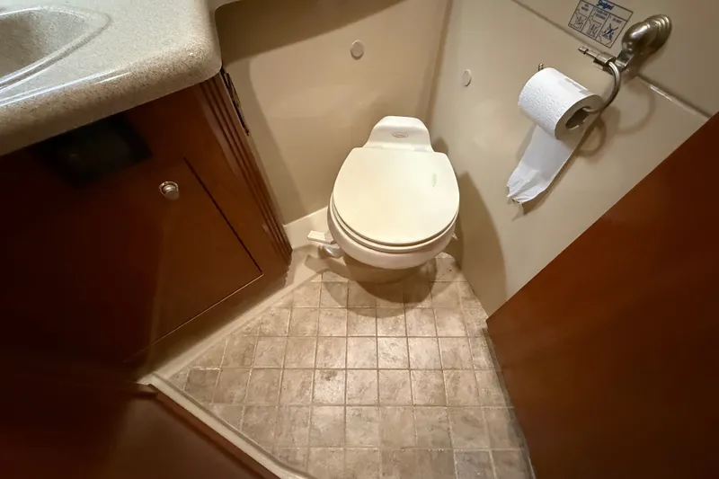 Slide: The Image of Bathroom interior of 2004 Cruisers Yachts 405 Express Motoryacht, featuring toilet and cabinetry. - 64