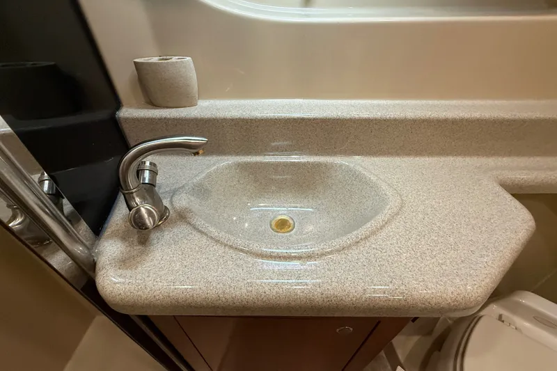 Slide: The Image of Bathroom sink in 2004 Cruisers Yachts 405 Express Motoryacht, featuring modern faucet and countertop. - 83
