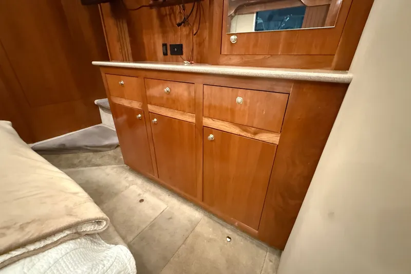 Slide: The Image of Wooden cabinetry in 2004 Cruisers Yachts 405 Express Motoryacht interior, featuring a countertop and mirror. - 78