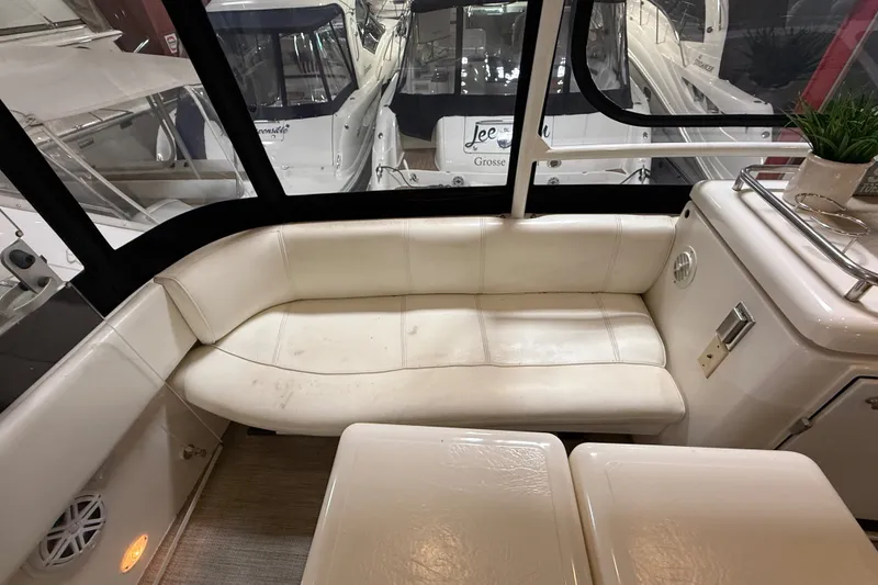 Slide: The Image of Interior of 2004 Cruisers Yachts 405 Express Motoryacht with white seating and table. - 15