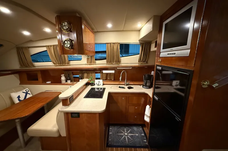 Slide: The Image of Luxurious 2004 Cruisers Yachts 405 Express Motoryacht interior with kitchen and dining area. - 39