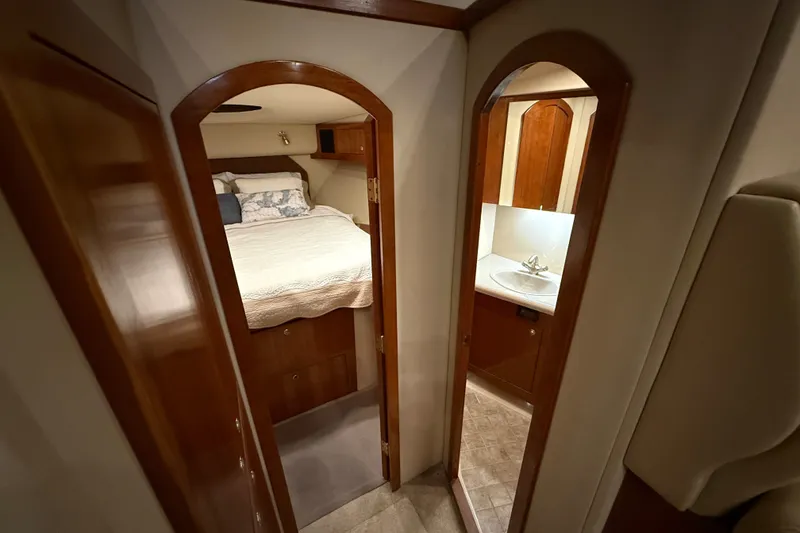 Slide: The Image of 2004 Cruisers Yachts 405 Express Motoryacht interior with cozy bedroom and bathroom. - 53