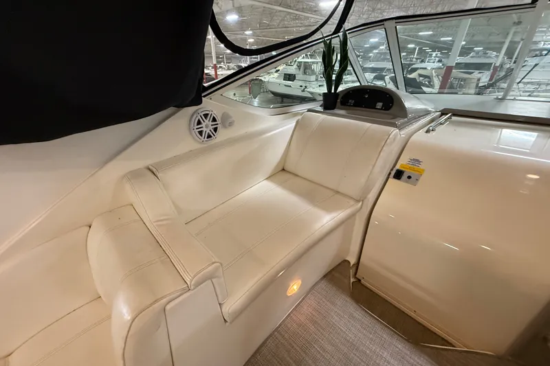 Slide: The Image of 2004 Cruisers Yachts 405 Express Motoryacht interior with white seating and dashboard. - 23