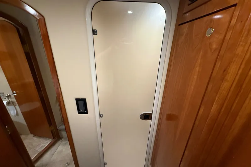 Slide: The Image of Interior of 2004 Cruisers Yachts 405 Express Motoryacht with wooden cabinetry and door. - 59