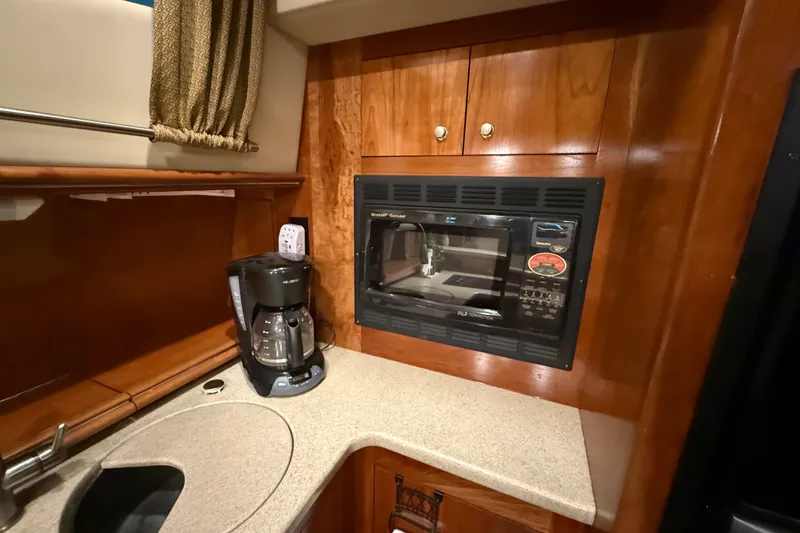 Slide: The Image of 2004 Cruisers Yachts 405 Express Motoryacht kitchen with microwave and coffee maker. - 42