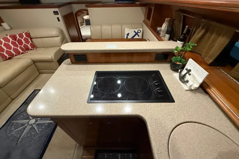 Slide: The Image of Luxurious 2004 Cruisers Yachts 405 Express Motoryacht interior with modern kitchen amenities. - 43