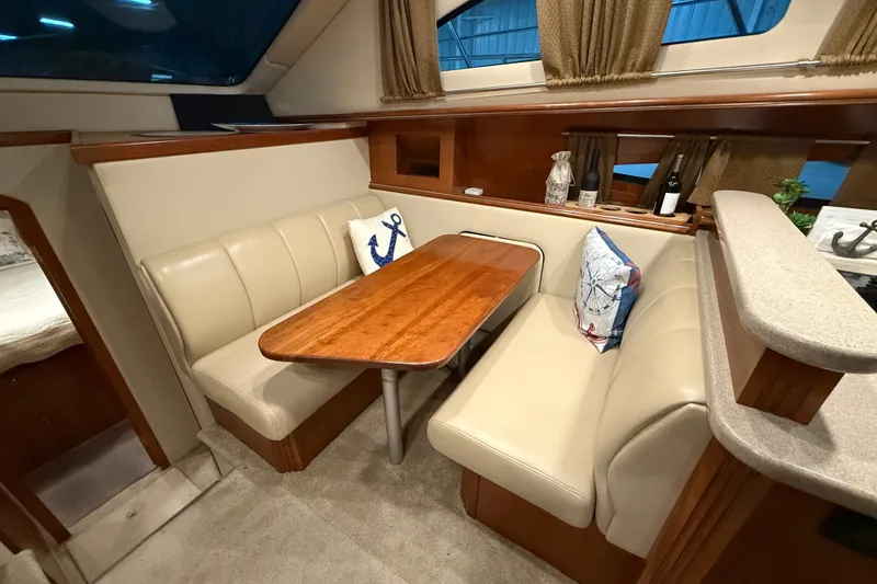 Slide: The Image of Luxurious 2004 Cruisers Yachts 405 Express Motoryacht interior with cozy dining area and elegant decor. - 49