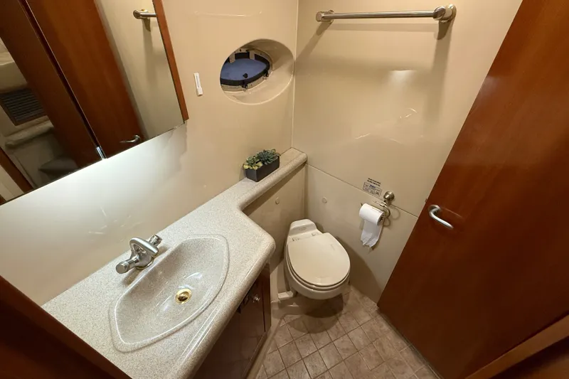 Slide: The Image of Bathroom interior of 2004 Cruisers Yachts 405 Express Motoryacht, featuring sink and toilet. - 68