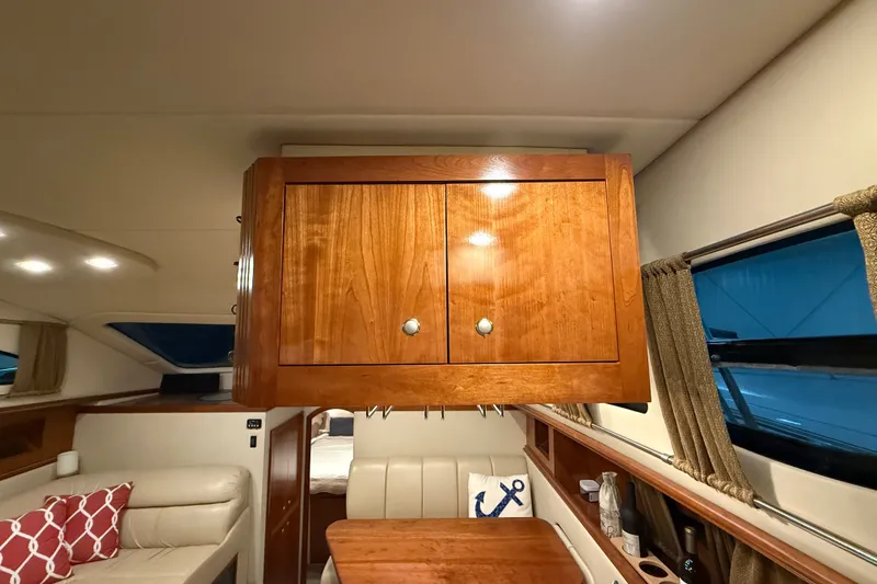 Slide: The Image of Interior of 2004 Cruisers Yachts 405 Express Motoryacht with wooden cabinetry and seating area. - 44