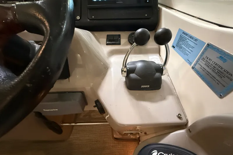 Slide: The Image of 2004 Cruisers Yachts 405 Express Motoryacht helm controls and steering wheel. - 31