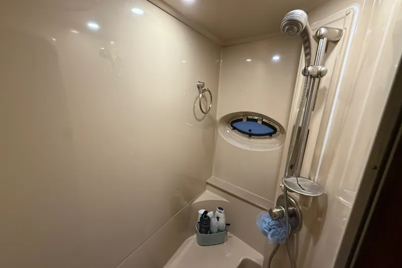 Slide: The Image of Shower area in 2004 Cruisers Yachts 405 Express Motoryacht with porthole and toiletries. - 60