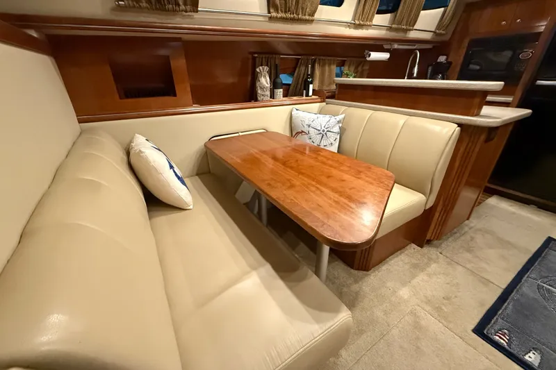 Slide: The Image of Luxurious 2004 Cruisers Yachts 405 Express Motoryacht interior with elegant dining area. - 51