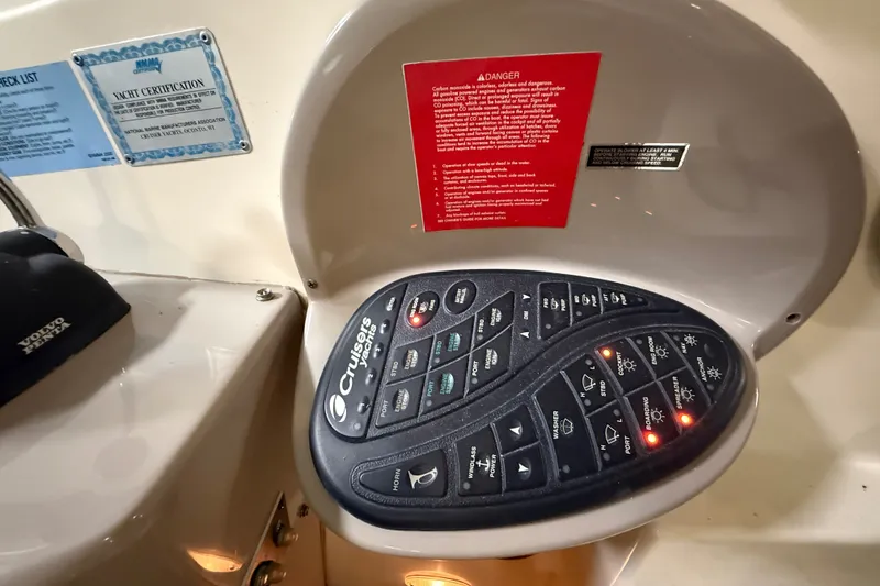 Slide: The Image of Control panel of a 2004 Cruisers Yachts 405 Express Motoryacht with various labeled buttons. - 32