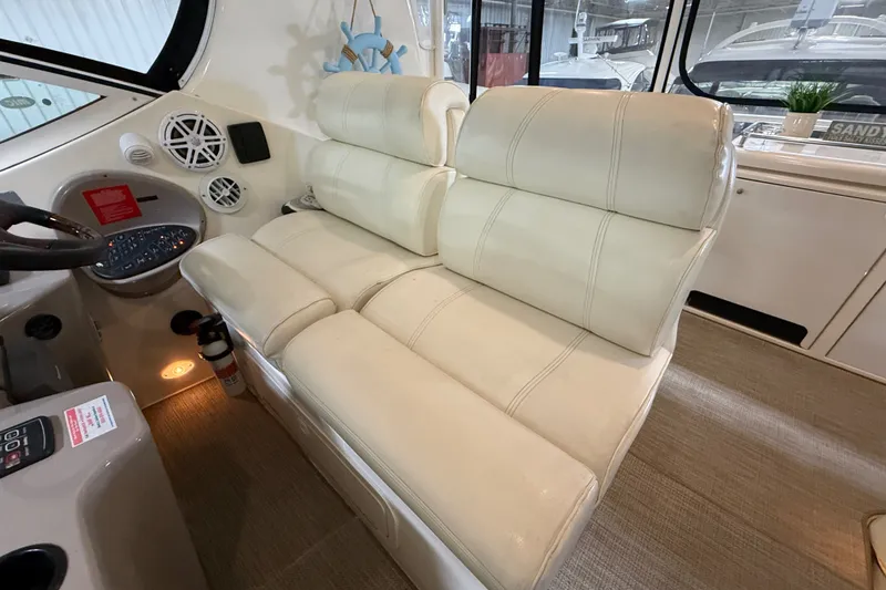 Slide: The Image of 2004 Cruisers Yachts 405 Express Motoryacht interior with beige leather seating and control panel. - 26