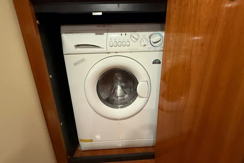Slide: The Image of Washing machine inside 2004 Cruisers Yachts 405 Express Motoryacht, wooden cabinetry. - 79