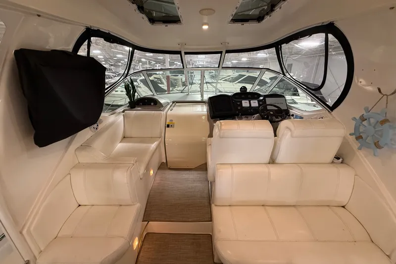 Slide: The Image of Interior of 2004 Cruisers Yachts 405 Express Motoryacht with white seating and helm controls. - 20