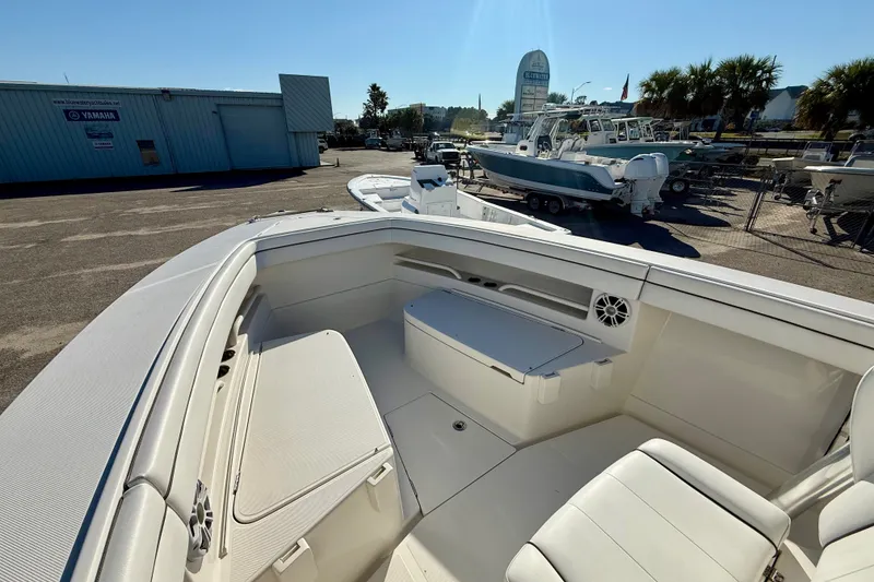 Slide: The Image of 2018 Jupiter 30 HFS boat interior with seating and storage, displayed outdoors. - 10