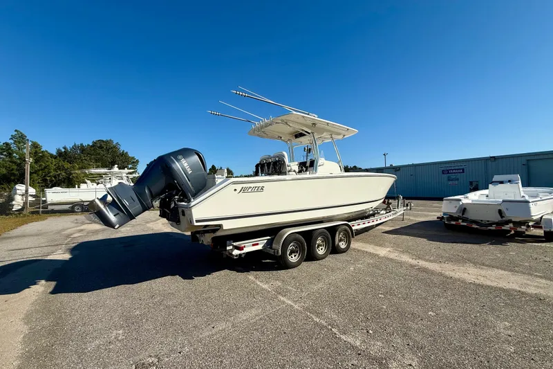 The Image of 2018 Jupiter 30 HFS boat on trailer with dual Yamaha engines, parked outdoors. - 0