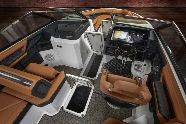 Slide: The Image of The image shows the cockpit of a modern Cobalt R8 boat with luxurious brown seats and a high-tech helm. - 14