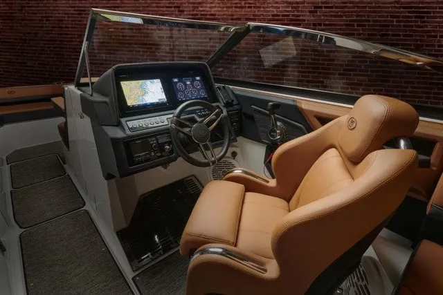 Slide: The Image of The image shows the cockpit of a Cobalt R8 boat with a luxurious leather seat and modern instruments. - 15