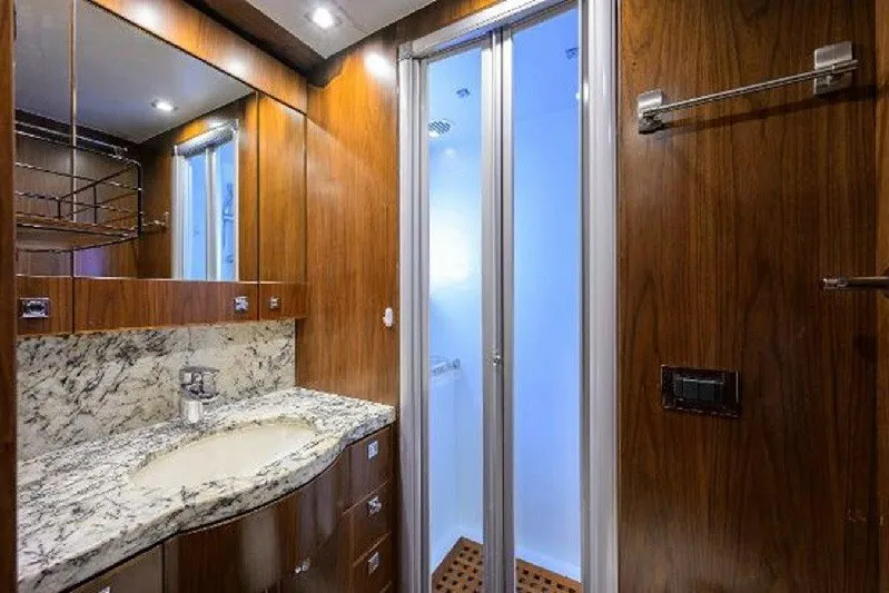 Slide: The Image of Luxurious bathroom in 2018 Hargrave Raised Pilothouse yacht with wood accents and marble countertop. - 64