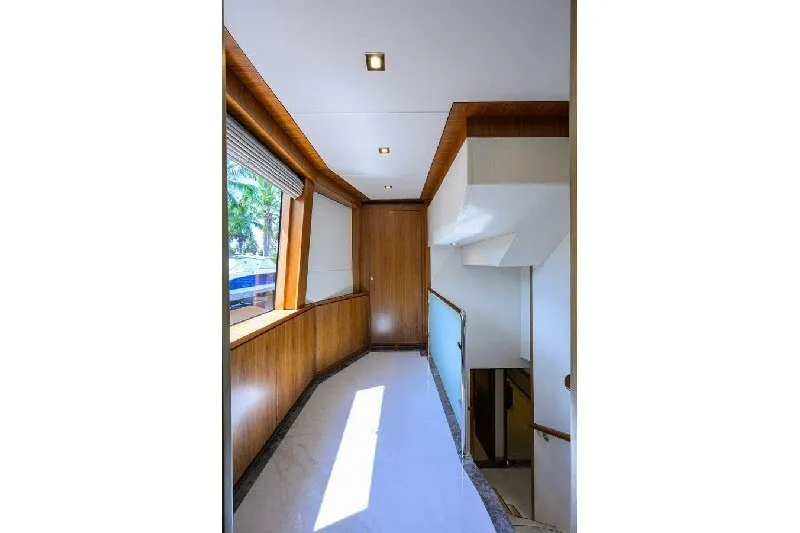 Slide: The Image of Luxurious interior hallway of 2018 Hargrave Raised Pilothouse yacht with wood paneling and modern lighting. - 35