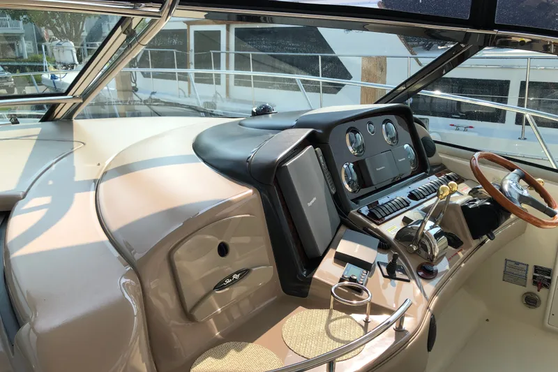 Slide: The Image of Helm of 2004 Sea Ray 420 Sundancer with steering wheel and navigation controls. - 8