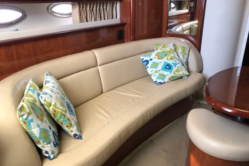 Slide: The Image of Luxurious interior of 2004 Sea Ray 420 Sundancer with beige leather seating and colorful cushions. - 17