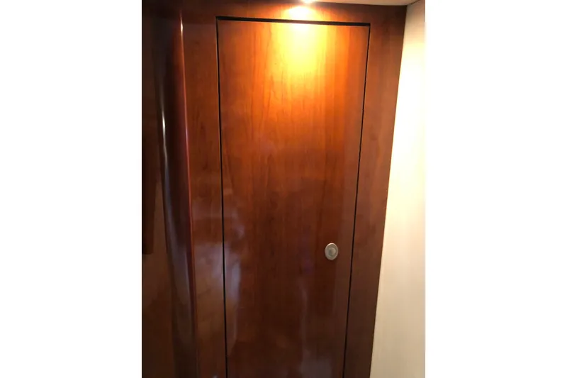 Slide: The Image of Wooden cabin door inside 2004 Sea Ray 420 Sundancer yacht, illuminated by overhead light. - 21