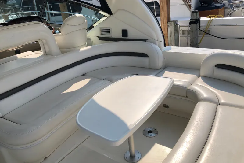 Slide: The Image of Luxurious interior seating of 2004 Sea Ray 420 Sundancer yacht with sleek white upholstery. - 12