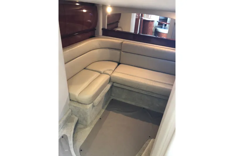 Slide: The Image of Interior of 2004 Sea Ray 420 Sundancer with beige leather seating and wood accents. - 20